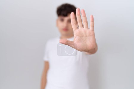 Photo for Young non binary man wearing casual white t shirt doing stop sing with palm of the hand. warning expression with negative and serious gesture on the face. - Royalty Free Image