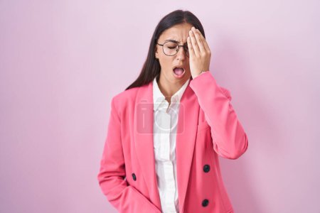 Photo for Young hispanic woman wearing business clothes and glasses yawning tired covering half face, eye and mouth with hand. face hurts in pain. - Royalty Free Image