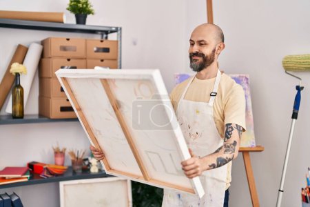 Photo for Young bald man artist smiling confident looking draw at art studio - Royalty Free Image