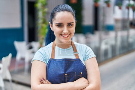 Photo for Young caucasian woman waitress smiling confident standing with arms crossed gesture at coffee shop terrace - Royalty Free Image
