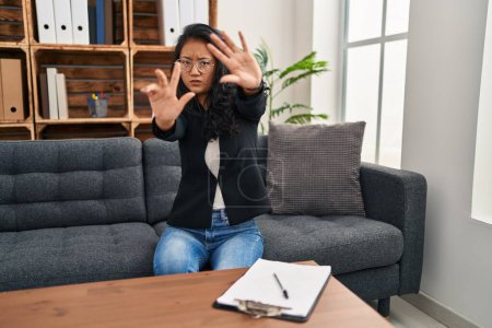 Photo for Young asian woman at consultation office doing frame using hands palms and fingers, camera perspective - Royalty Free Image