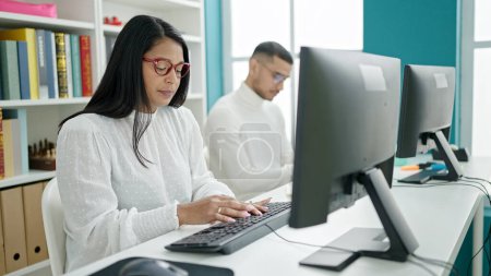 Photo for Man and woman students using computer studying at university classroom - Royalty Free Image