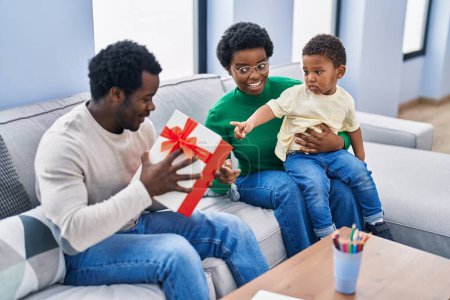 Photo for African american family surprise with gift at home - Royalty Free Image