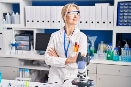 Photo for Young blonde woman scientist standing with arms crossed gesture at laboratory - Royalty Free Image