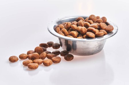 Photo for Delicious bowl of dog food balls over isolated white background - Royalty Free Image
