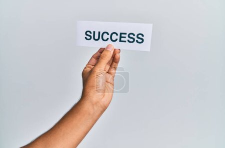 Photo for Hand of caucasian man holding paper with success word over isolated white background - Royalty Free Image