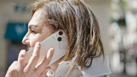 Photo for Middle age hispanic woman speaking on the phone at street - Royalty Free Image