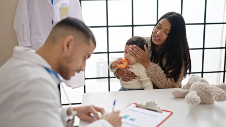 Photo for Couple and son having medical consultation at clinic - Royalty Free Image