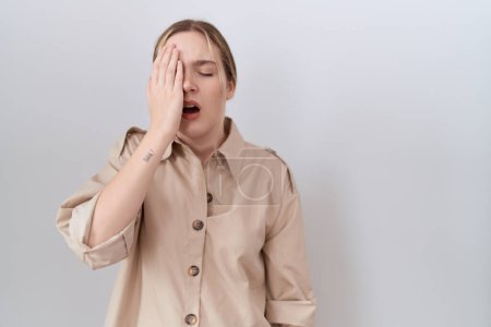 Photo for Young caucasian woman wearing casual shirt yawning tired covering half face, eye and mouth with hand. face hurts in pain. - Royalty Free Image