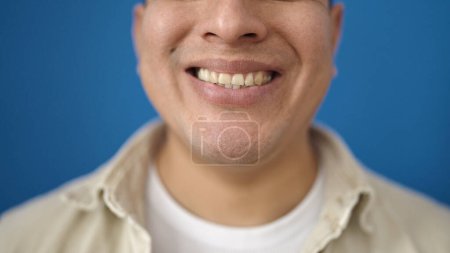 Photo for Young hispanic man smiling confident over isolated blue background - Royalty Free Image