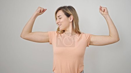 Photo for Young blonde woman smiling confident doing strong gesture with arms over isolated white background - Royalty Free Image
