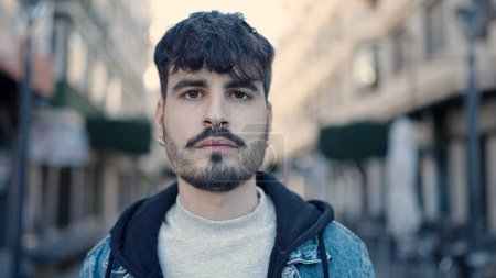 Photo for Young hispanic man standing with serious expression at street - Royalty Free Image