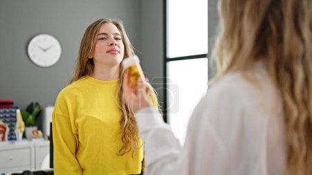 Photo for Young blonde woman doctor and patient prescribing pills treatment at clinic - Royalty Free Image