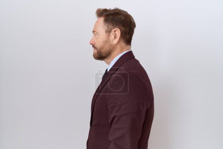 Photo for Middle age business man with beard wearing suit and tie looking to side, relax profile pose with natural face and confident smile. - Royalty Free Image