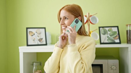 Photo for Young blonde woman smiling confident talking on smartphone at home - Royalty Free Image