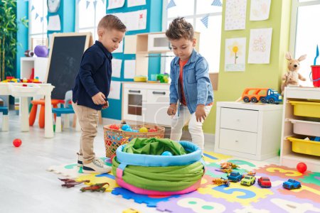 Photo for Adorable boys standing with relaxed expression playing at kindergarten - Royalty Free Image