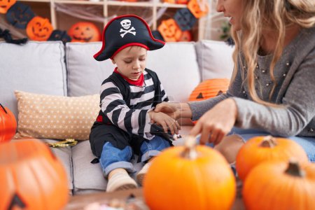 Photo for Adorable caucasian boy wearing pirate costume having draw on hand at home - Royalty Free Image