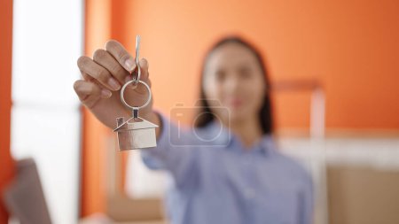 Photo for Young beautiful hispanic woman smiling confident holding new house keys at new home - Royalty Free Image