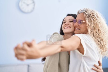 Photo for Two women mother and daughter dancing at home - Royalty Free Image