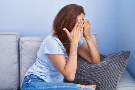 Photo for Young woman stressed sitting on sofa at home - Royalty Free Image