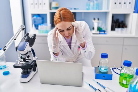 Photo for Young caucasian woman scientist stressed using laptop working at laboratory - Royalty Free Image