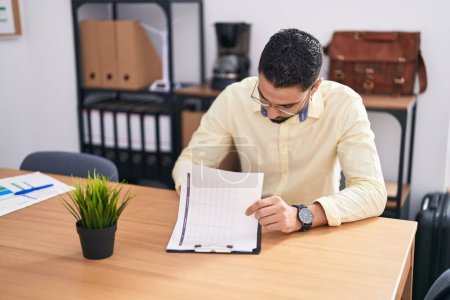 Photo for Young arab man business worker writing on document working at office - Royalty Free Image