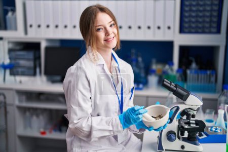 Photo for Young caucasian woman scientist smiling confident working at laboratory - Royalty Free Image