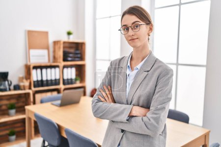 Photo for Young caucasian woman business worker smiling confident standing with arms crossed gesture at office - Royalty Free Image