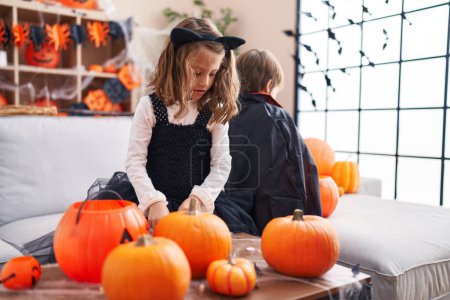 Photo for Adorable boy and girl having halloween party standing at home - Royalty Free Image