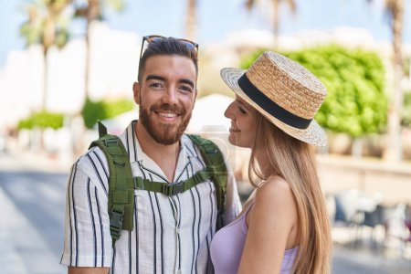 Photo for Man and woman tourist couple smiling confident hugging each other at street - Royalty Free Image