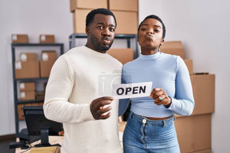 Photo for Young african american couple working at small business ecommerce looking at the camera blowing a kiss being lovely and sexy. love expression. - Royalty Free Image