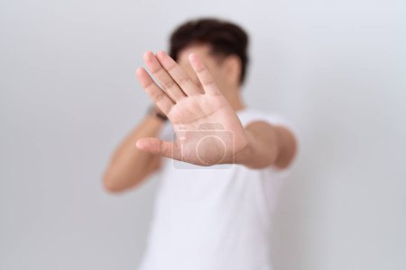 Photo for Young non binary man wearing casual white t shirt covering eyes with hands and doing stop gesture with sad and fear expression. embarrassed and negative concept. - Royalty Free Image