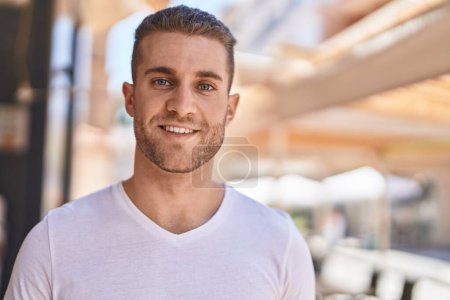 Foto de Young caucasian man smiling confident standing at street - Imagen libre de derechos