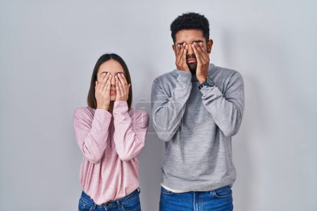 Photo for Young hispanic couple standing together rubbing eyes for fatigue and headache, sleepy and tired expression. vision problem - Royalty Free Image