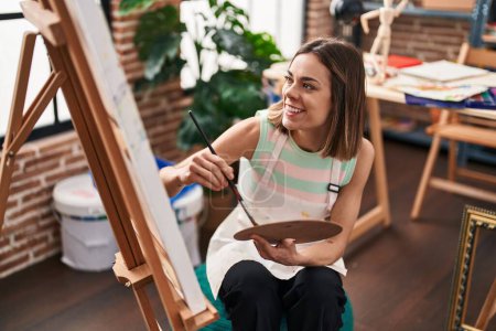 Young beautiful hispanic woman artist smiling confident drawing at art studio