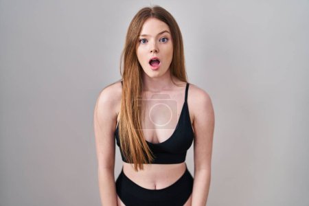 Photo for Young caucasian woman wearing lingerie afraid and shocked with surprise expression, fear and excited face. - Royalty Free Image