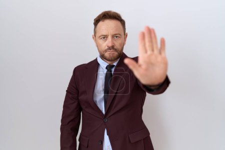 Photo for Middle age business man with beard wearing suit and tie doing stop sing with palm of the hand. warning expression with negative and serious gesture on the face. - Royalty Free Image