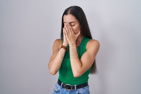 Photo for Young woman standing over isolated background with sad expression covering face with hands while crying. depression concept. - Royalty Free Image