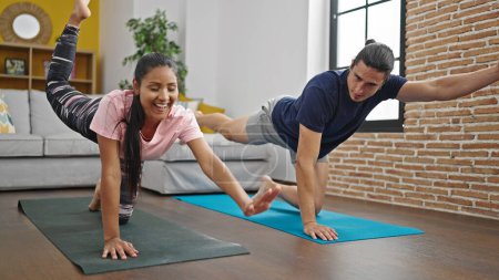 Photo for Man and woman couple training core exercise at home - Royalty Free Image