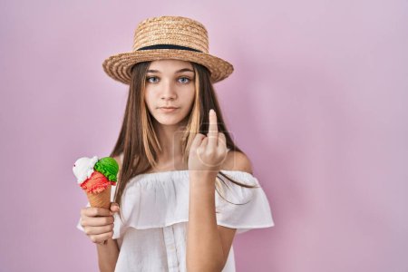Téléchargez les photos : Teenager girl holding ice cream showing middle finger, impolite and rude fuck off expression - en image libre de droit