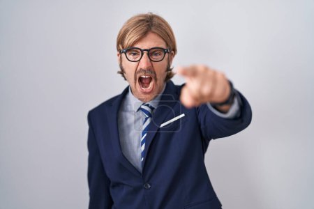 Photo for Caucasian man with mustache wearing business clothes pointing displeased and frustrated to the camera, angry and furious with you - Royalty Free Image