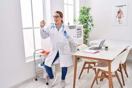 Photo for Young beautiful hispanic woman doctor smiling confident dancing at clinic - Royalty Free Image