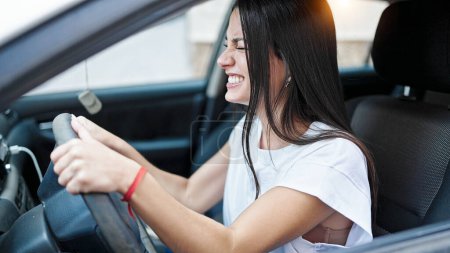 Photo for Young beautiful hispanic woman stressed driving car at street - Royalty Free Image