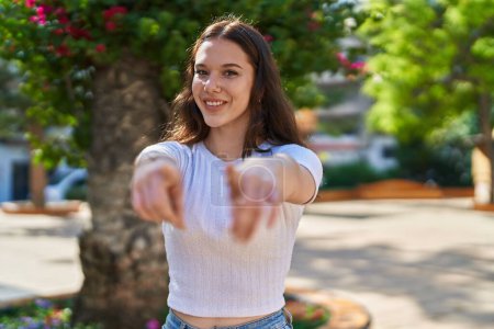 Photo for Young woman smiling confident pointing with fingers at street - Royalty Free Image