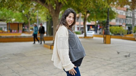 Photo for Young pregnant woman smiling confident standing at park - Royalty Free Image