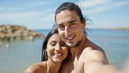 Photo for Man and woman tourist couple standing together make selfie by camera at beach - Royalty Free Image