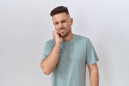 Photo for Hispanic man with beard standing over white background touching mouth with hand with painful expression because of toothache or dental illness on teeth. dentist - Royalty Free Image