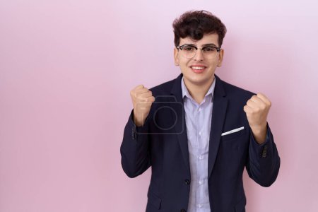 Photo for Young non binary man with beard wearing suit and tie celebrating surprised and amazed for success with arms raised and open eyes. winner concept. - Royalty Free Image