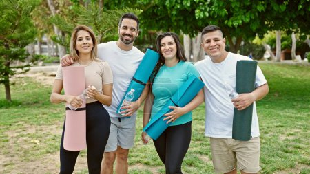 Photo for Group of people smiling confident holding yoga mat at park - Royalty Free Image