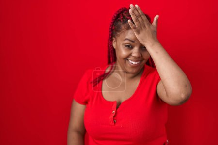 Photo for African american woman with braided hair standing over red background surprised with hand on head for mistake, remember error. forgot, bad memory concept. - Royalty Free Image